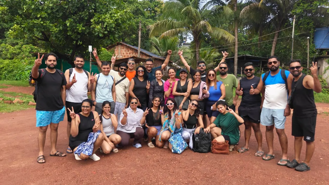 The group gathered under coconut palms at the start of a jungle trek