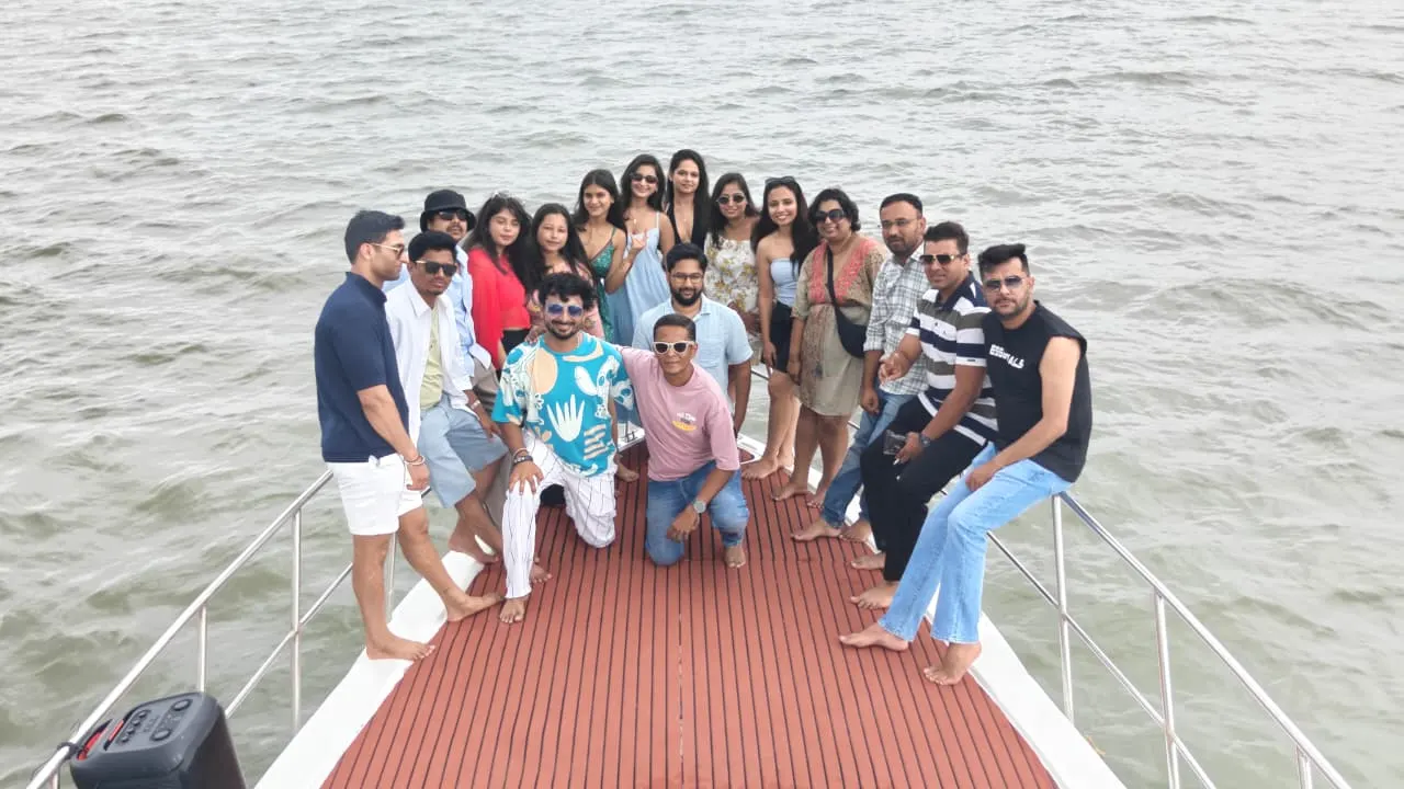 A Goa Unseen group posing on the bow of a private yacht